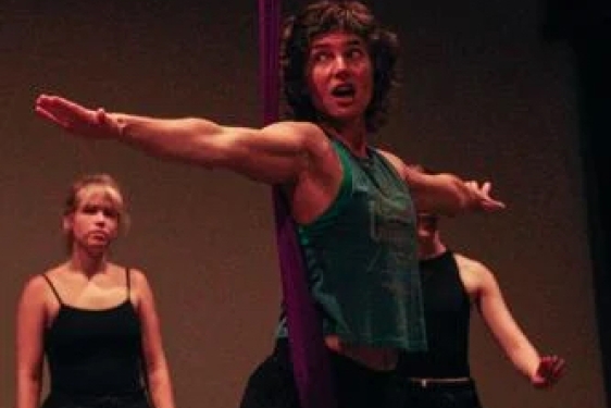 photo of woman arms extended, with two people in background